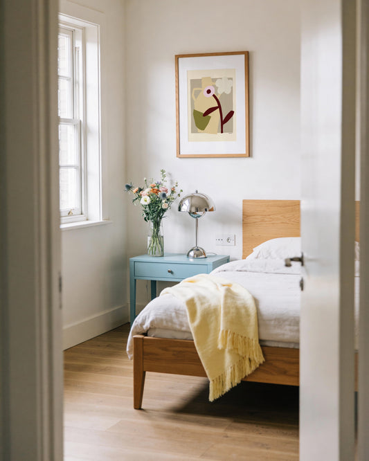 Modern abstract floral print featuring a sculptural vase, white flower and earthy neutral tones