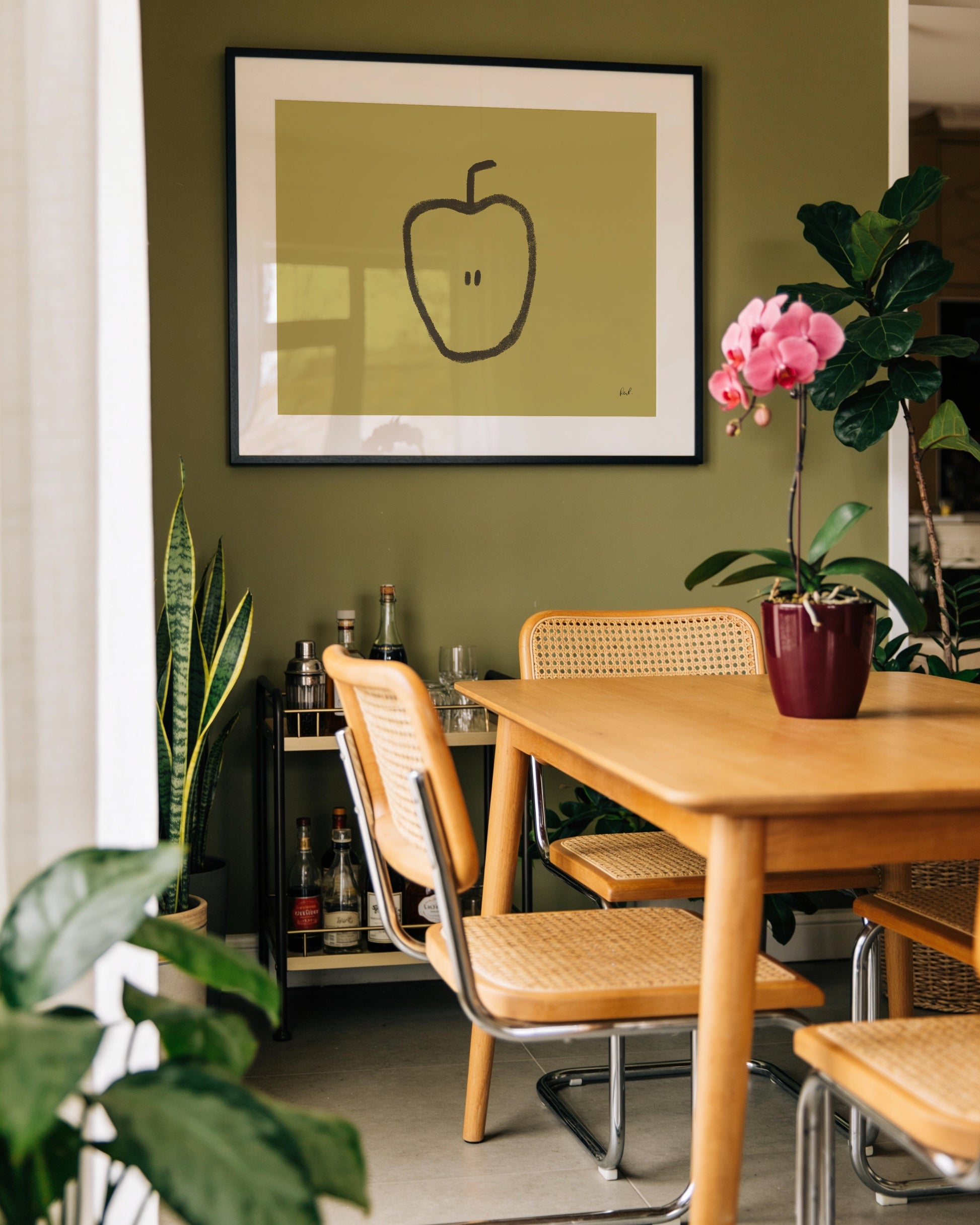 Minimalist hand-drawn apple printable wall art with a black apple illustration on a muted olive green background