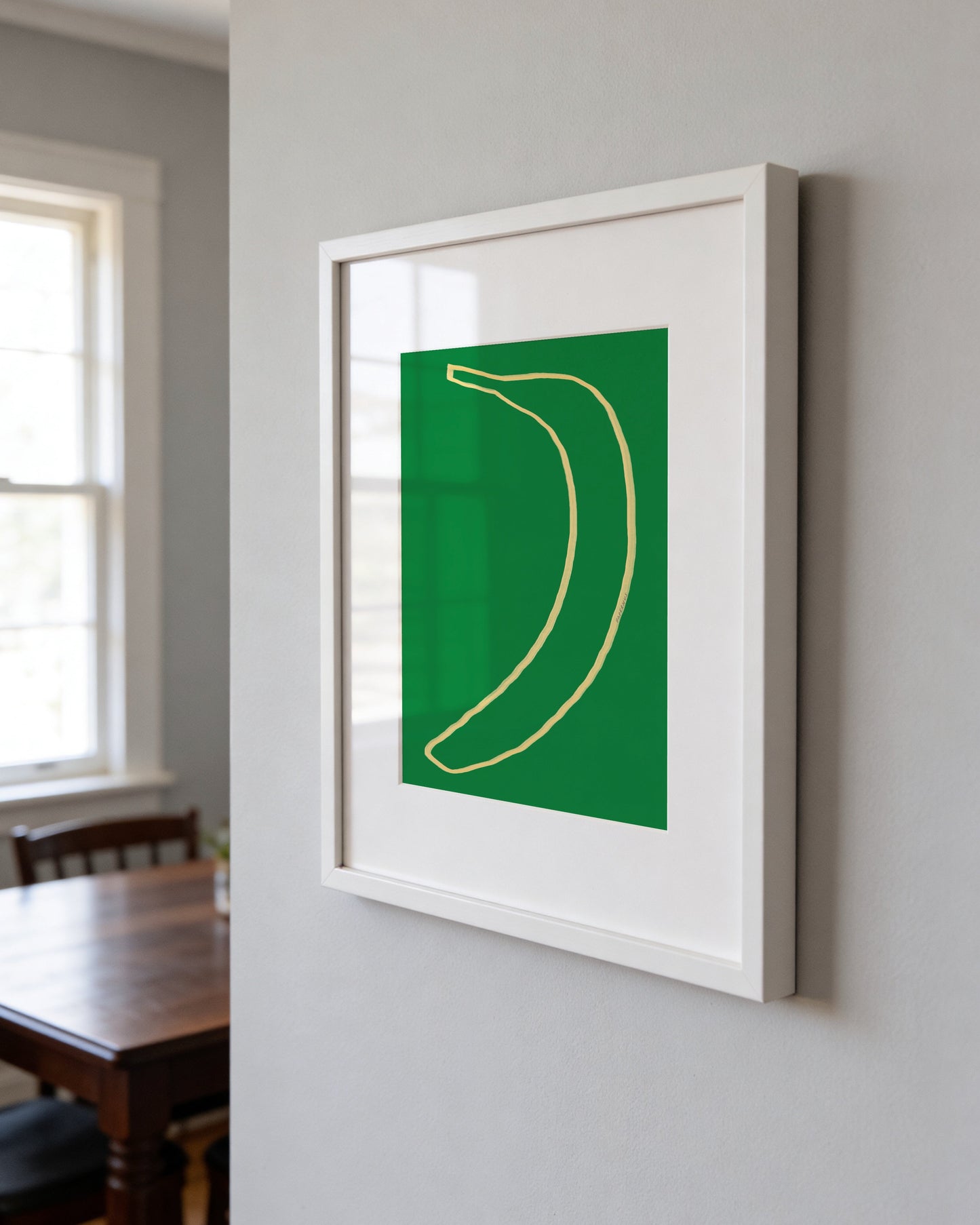Minimal banana illustration on a green background