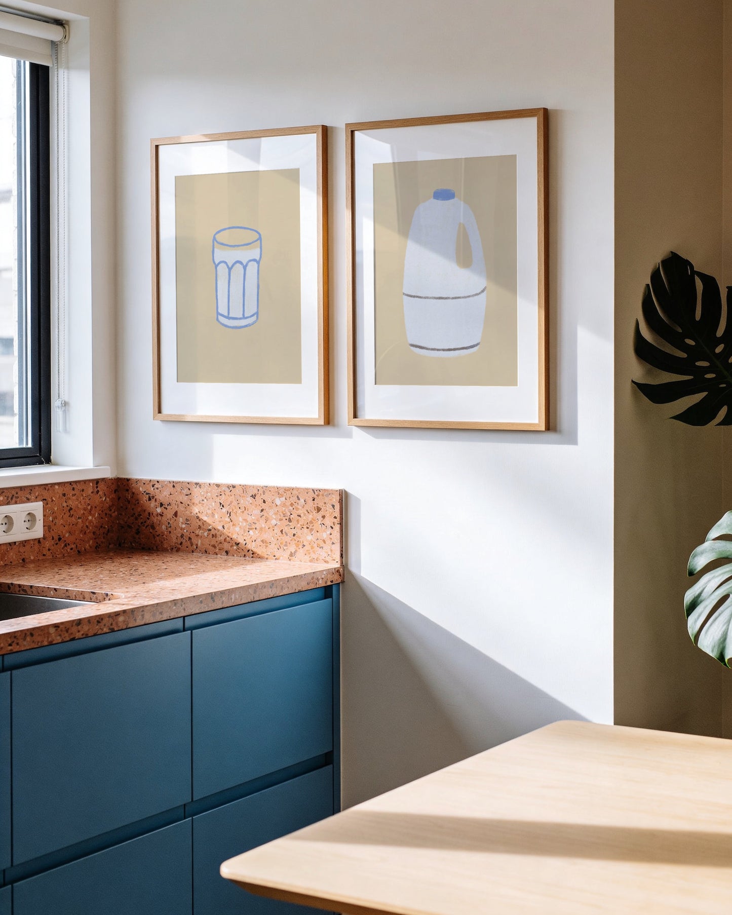Set of two minimalist kitchen prints featuring a milk bottle and drinking glass in soft neutral colours