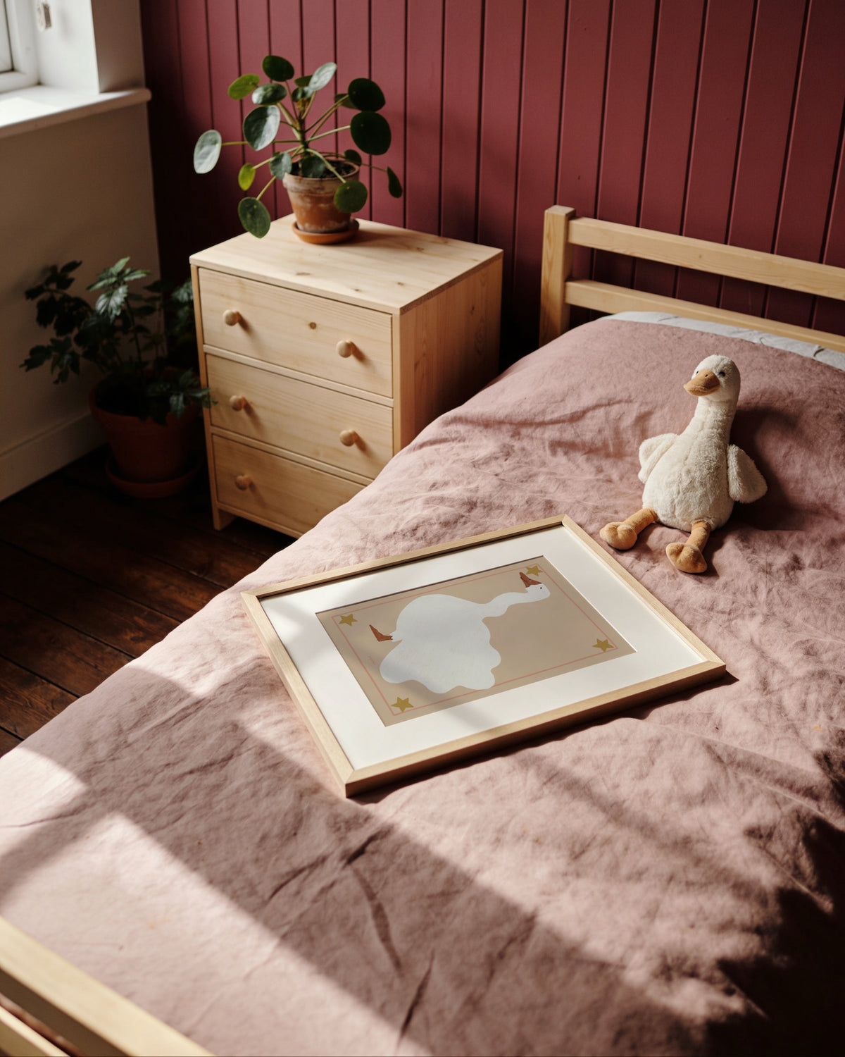 Vintage-inspired goose illustration with star details and blush pink border in soft neutral tones